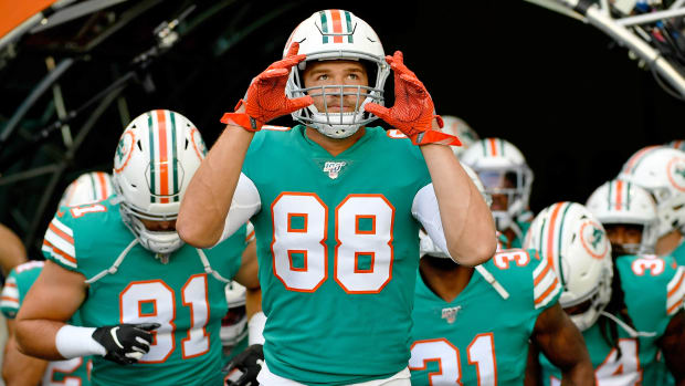 Dolphins tight end Mike Gesicki leads team onto field.